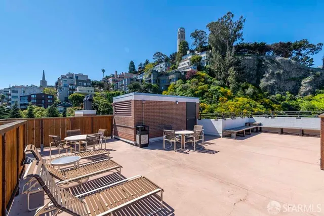 a view of a patio with a table and chairs