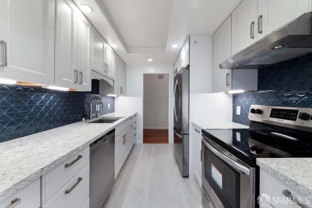 a kitchen with a sink stove and refrigerator