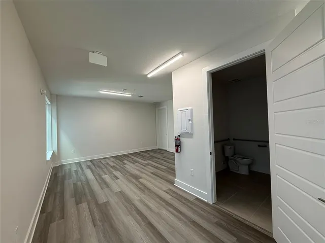 a view of a room with wooden floor