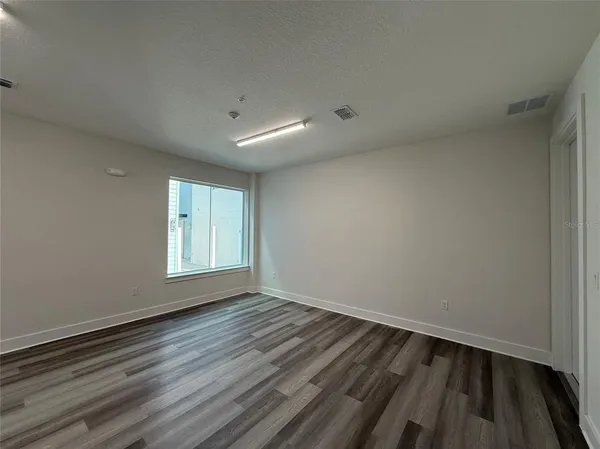 a view of wooden floor in an empty room