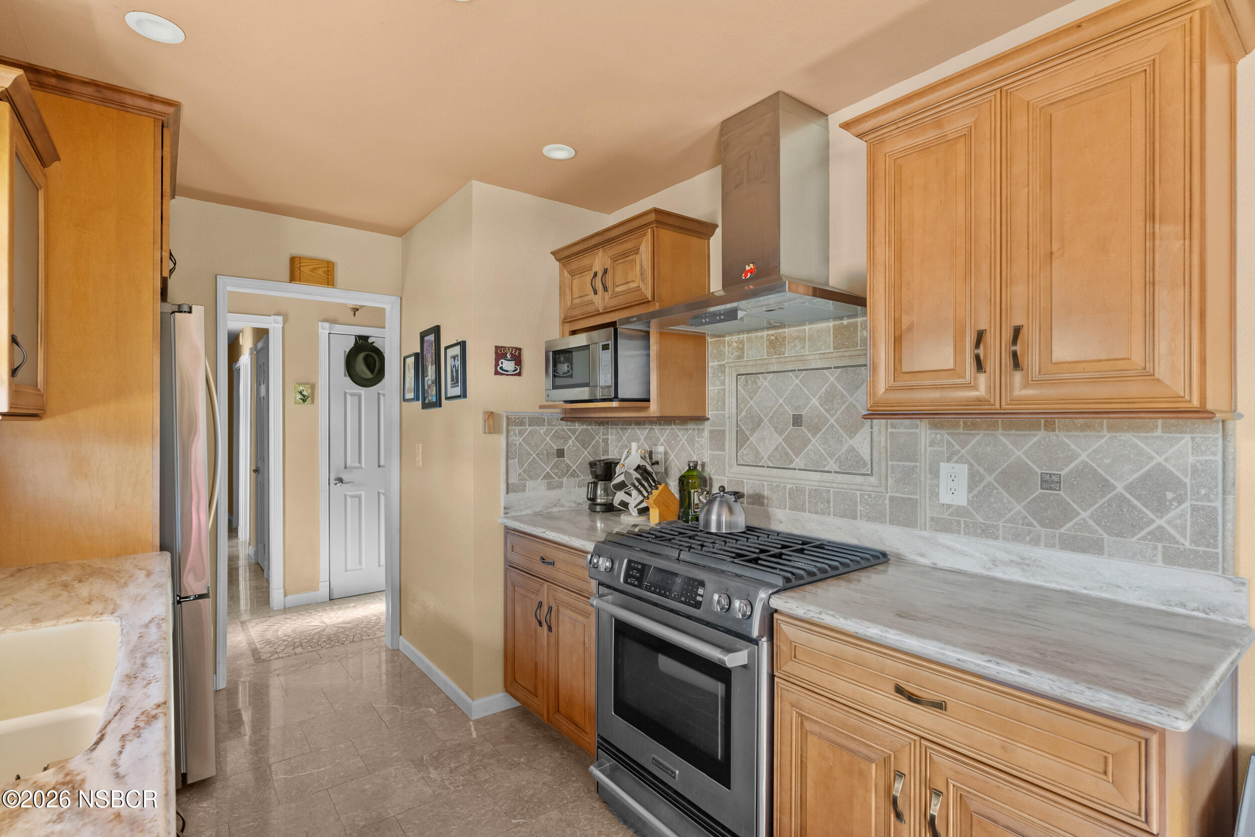 1157 Glines Avenue Santa Maria, CA 93455 - Photo 19 of 41 a kitchen with stainless steel appliances granite countertop a refrigerator and a stove