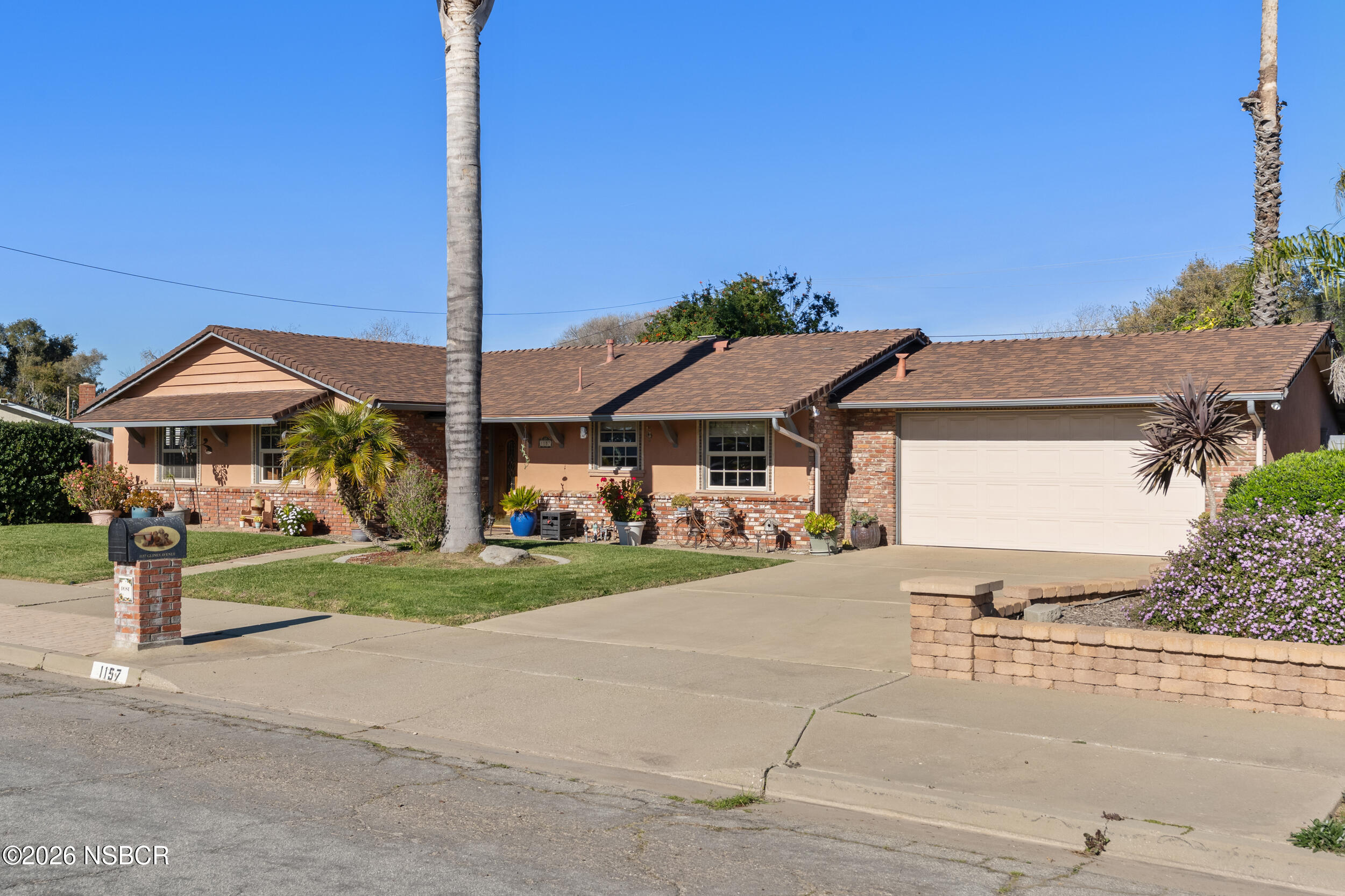 1157 Glines Avenue Santa Maria, CA 93455 - Photo 2 of 41 a view of a house with a yard and table and chairs under an umbrella