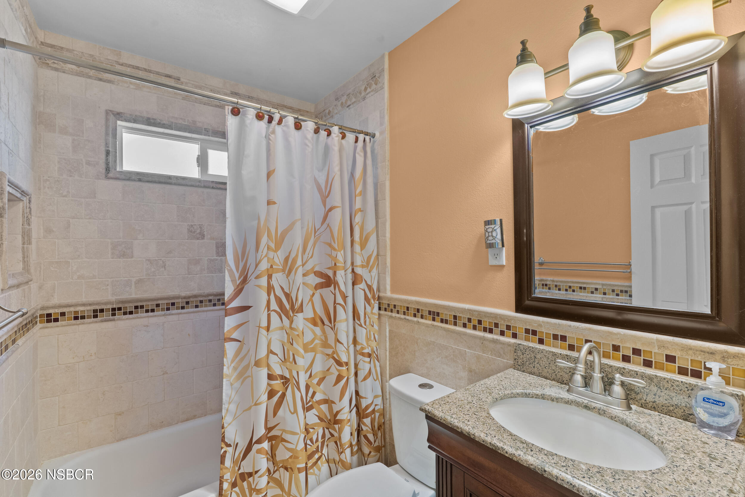 1157 Glines Avenue Santa Maria, CA 93455 - Photo 23 of 41 a bathroom with a granite countertop sink a mirror a vanity and a shower