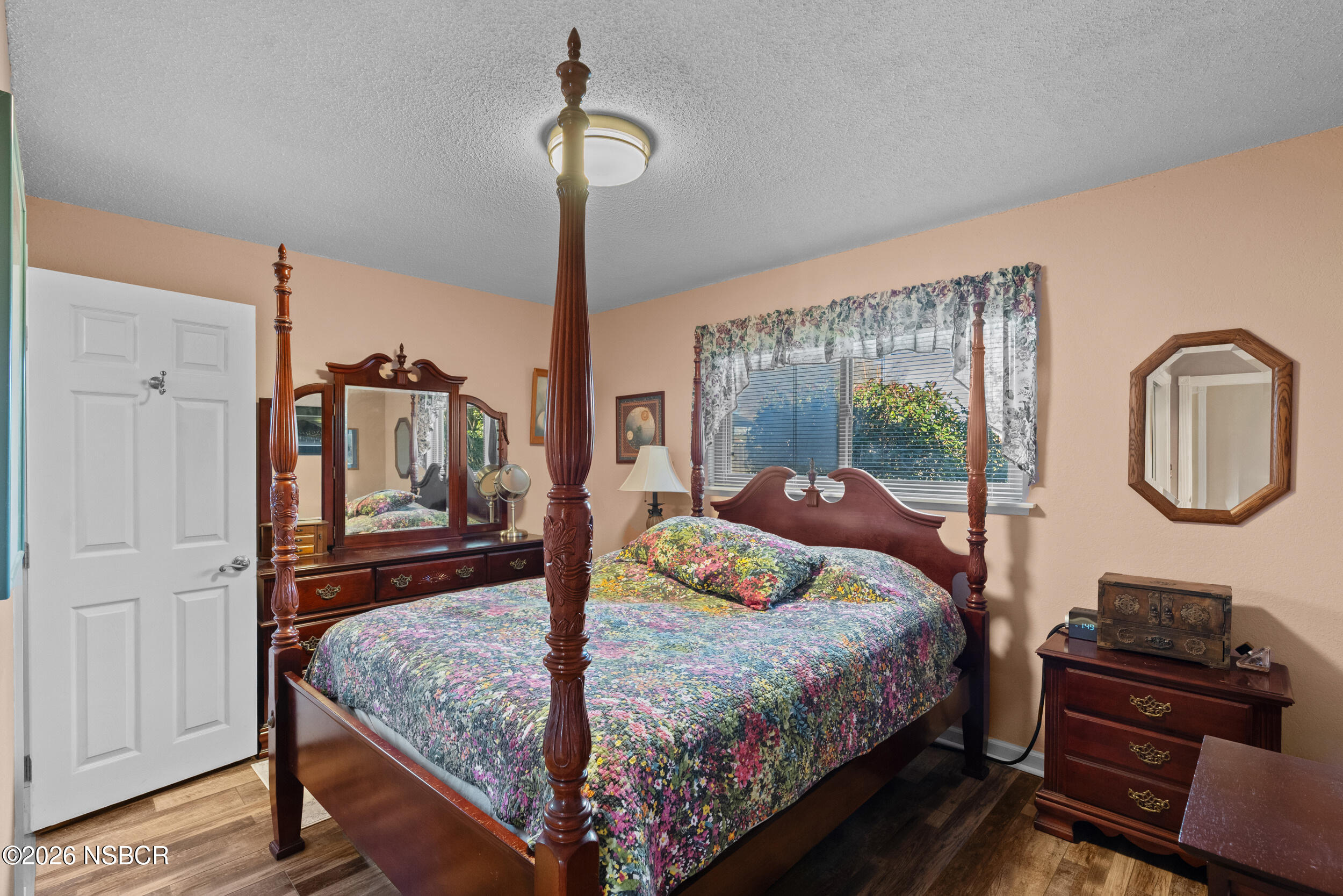1157 Glines Avenue Santa Maria, CA 93455 - Photo 26 of 41 a bedroom with a bed a dresser next to a window