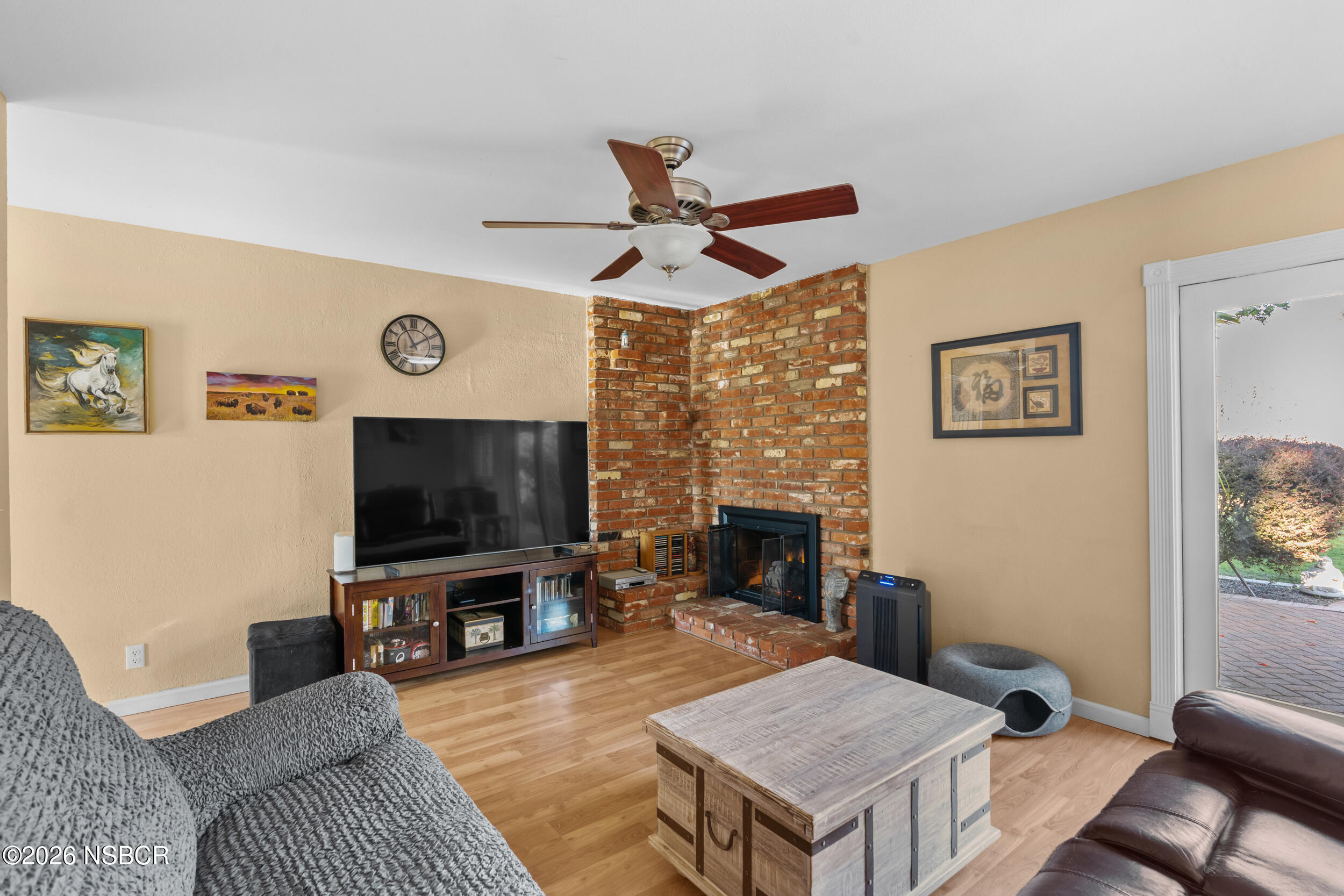 1157 Glines Avenue Santa Maria, CA 93455 - Photo 5 of 41 a living room with furniture a flat screen tv and a fireplace