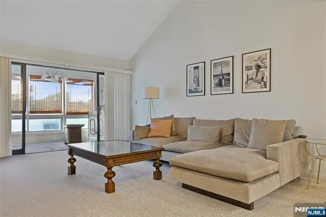 a living room with a bed furniture and a window