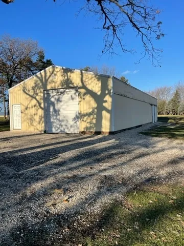 a view of backyard with wooden fence