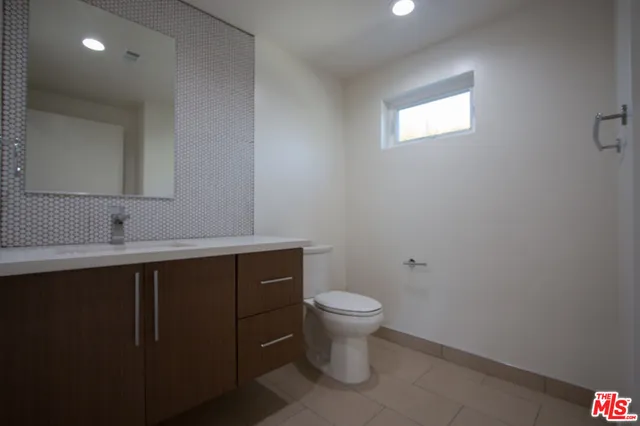 a bathroom with a sink toilet and vanity
