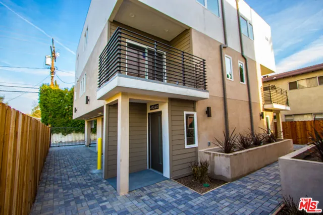 a view of a brick house with many windows