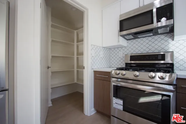 a kitchen with a stove and a microwave