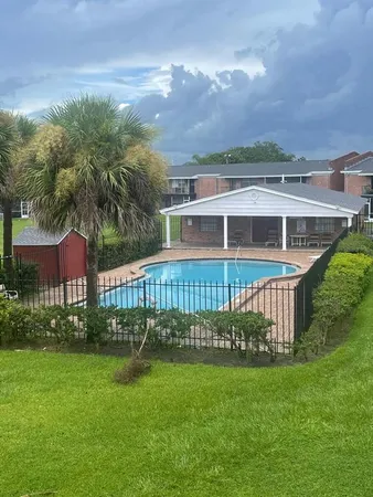a view of a house with a big yard and potted plants