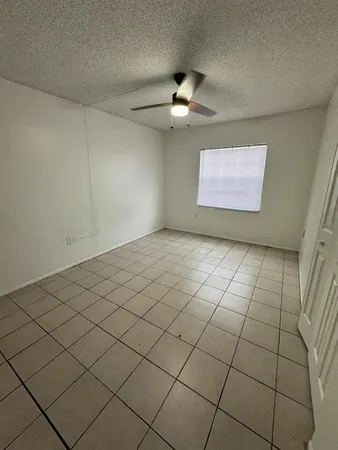 a view of an empty room and a window