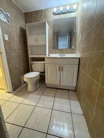 a bathroom with a toilet a sink and a mirror