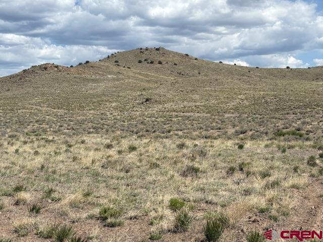769 Circle Mesa Road Del Norte, CO 81132 - Photo 3 of 7 a view of a large building with mountains in the background