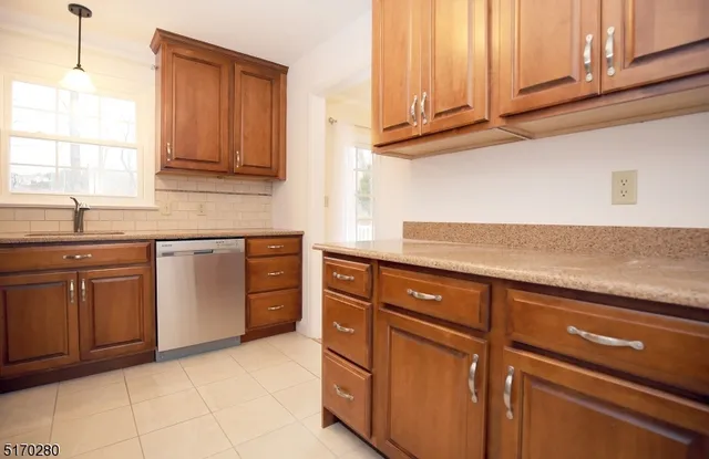 a kitchen with cabinets appliances and a sink
