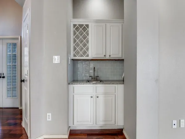 a view of kitchen with granite countertop cabinets and outdoor space