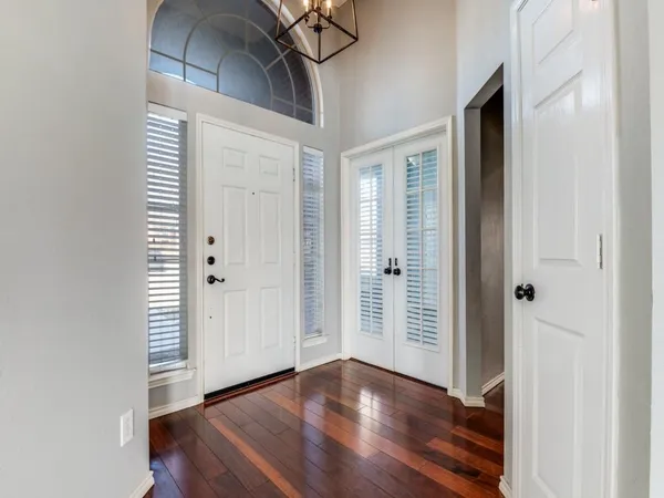 an empty room with wooden floor and closet