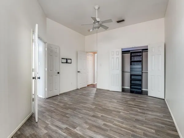 a view of an empty room with wooden floor