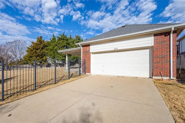 a view of backyard with small cabin and wooden fence