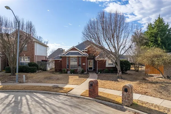 a front view of a house with a yard covered in snow
