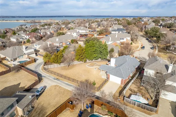 an aerial view of a house with a yard and lake view
