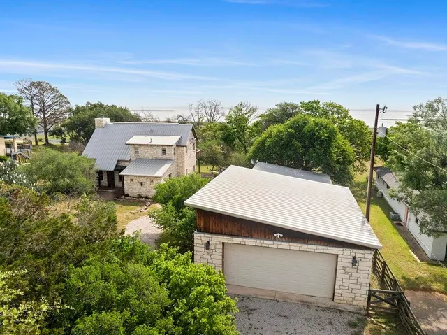 an aerial view of a house with a yard