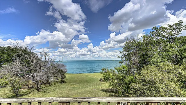 a view of lake from next to a yard