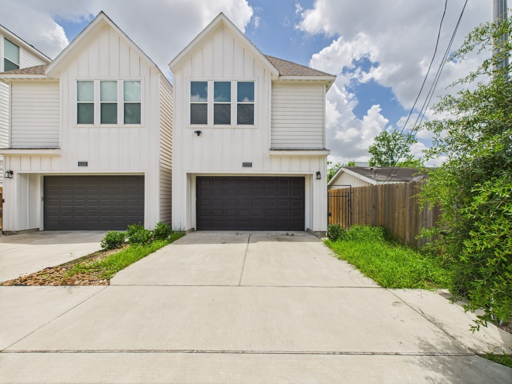 a front view of a house with a yard and a garage