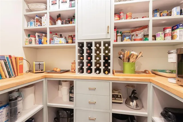 a kitchen with cabinets stainless steel appliances a sink and a window