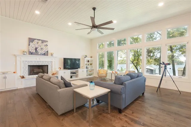 a living room with furniture a large window and a fireplace