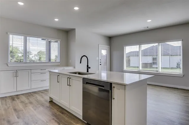 a kitchen with a sink stove and cabinets