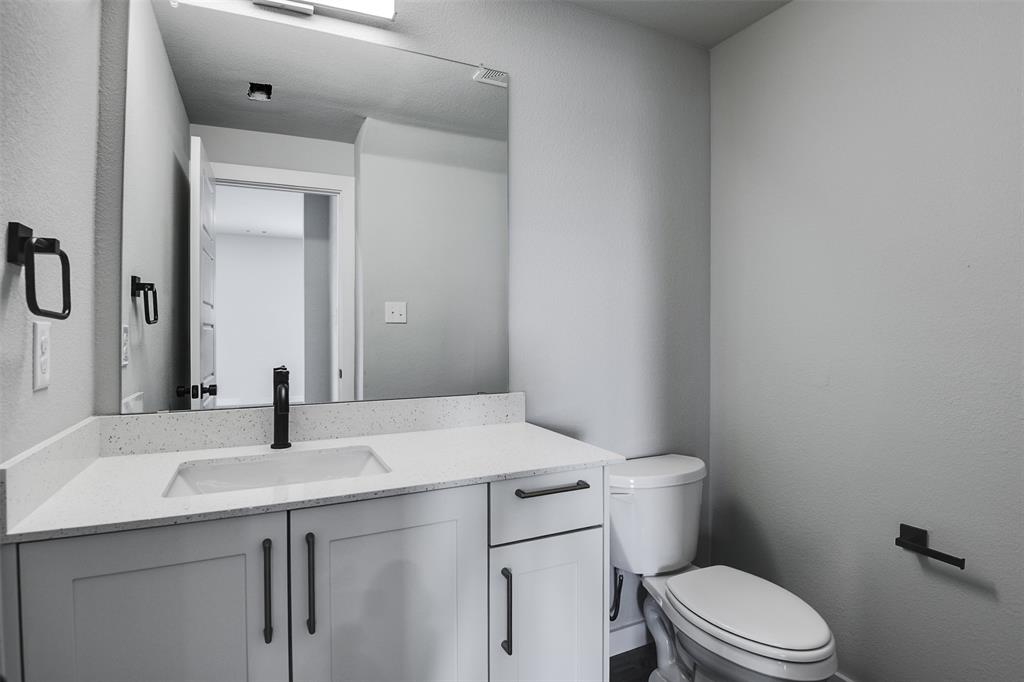 4042 Clovis Street Midlothian, TX 76065 - Photo 5 of 22 a bathroom with a sink vanity mirror and toilet