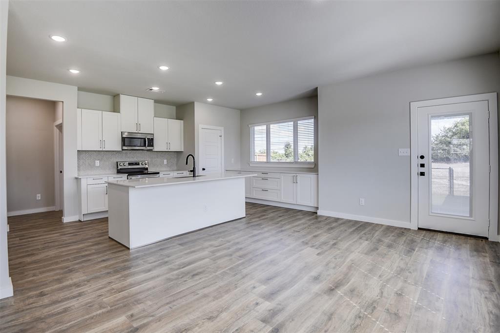 4042 Clovis Street Midlothian, TX 76065 - Photo 6 of 22 a view of kitchen with granite countertop cabinets and wooden floor