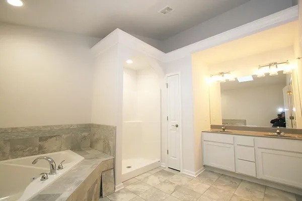 a bathroom with a bathtub and a sink