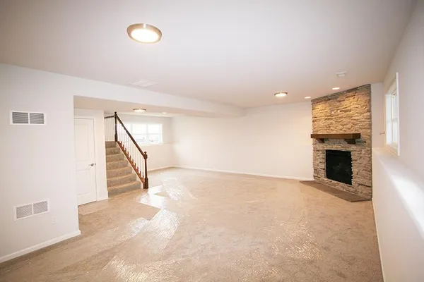 a view of an empty room with a fireplace