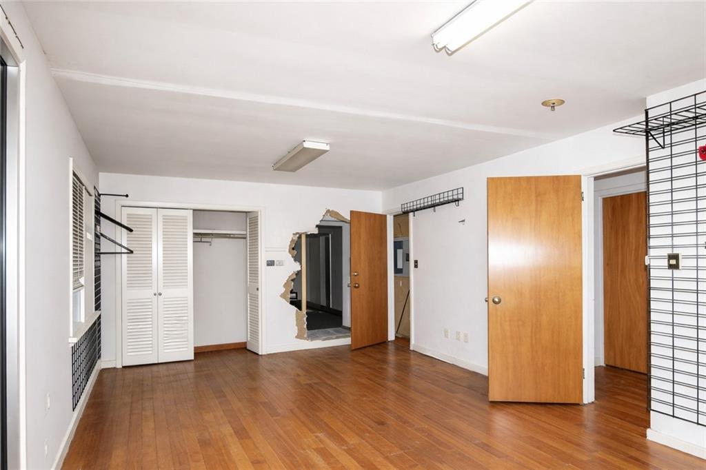 5195 Austell Road Austell, GA 30106 - Photo 20 of 34 a view of an empty room with wooden floor and a window