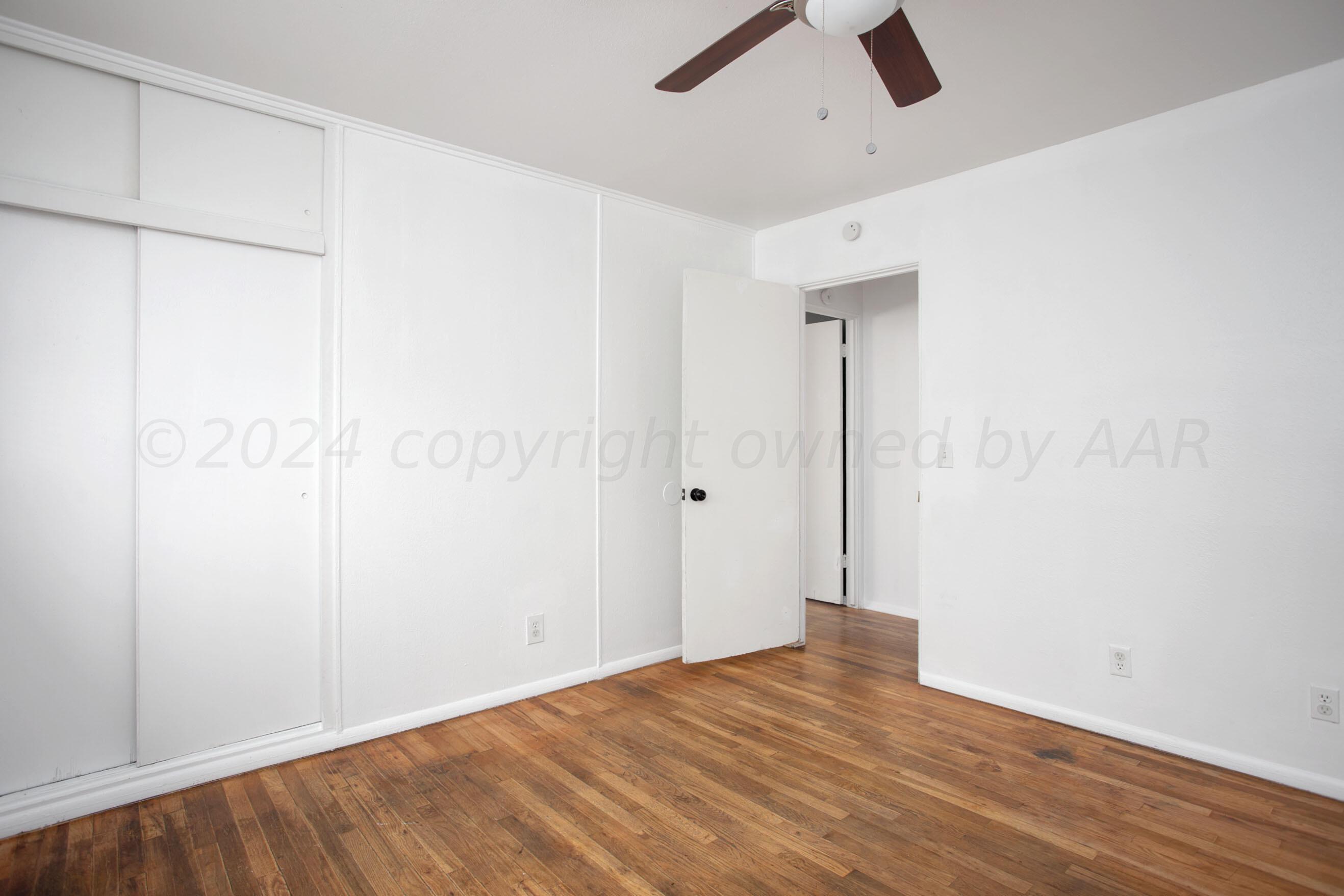 5318 Albert Avenue Amarillo, TX 79106 - Photo 13 of 24 wooden floor in an empty room