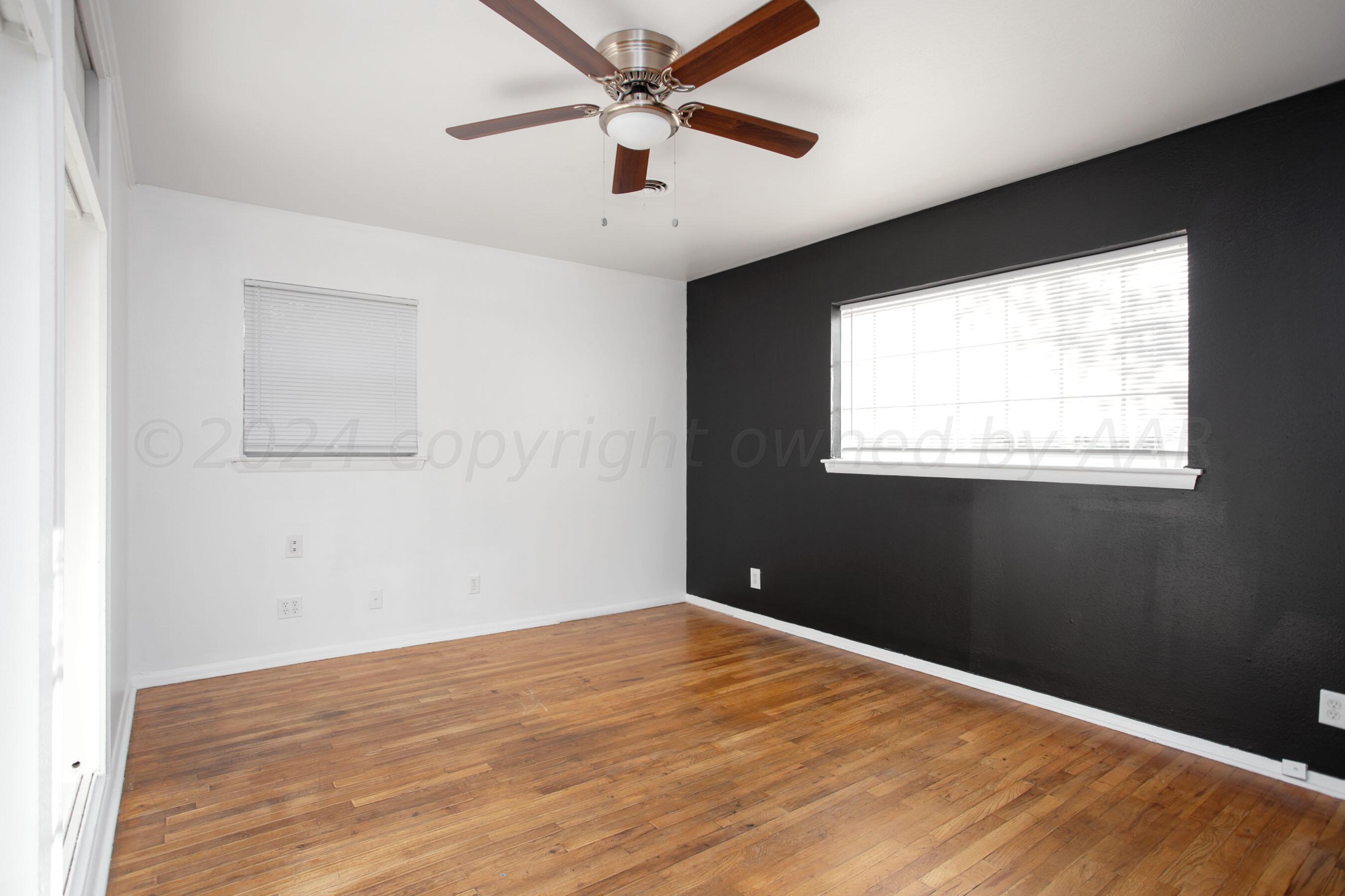 5318 Albert Avenue Amarillo, TX 79106 - Photo 14 of 24 a view of a big room with wooden floor and windows