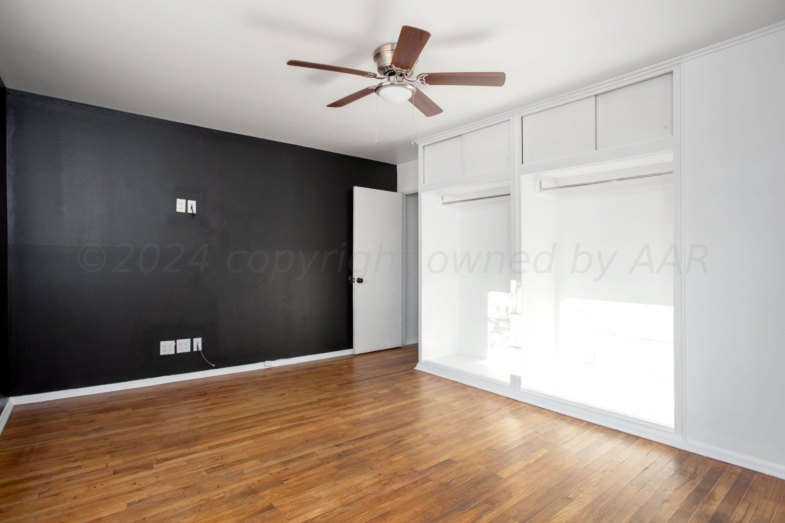 5318 Albert Avenue Amarillo, TX 79106 - Photo 15 of 24 a view of an empty room with wooden floor