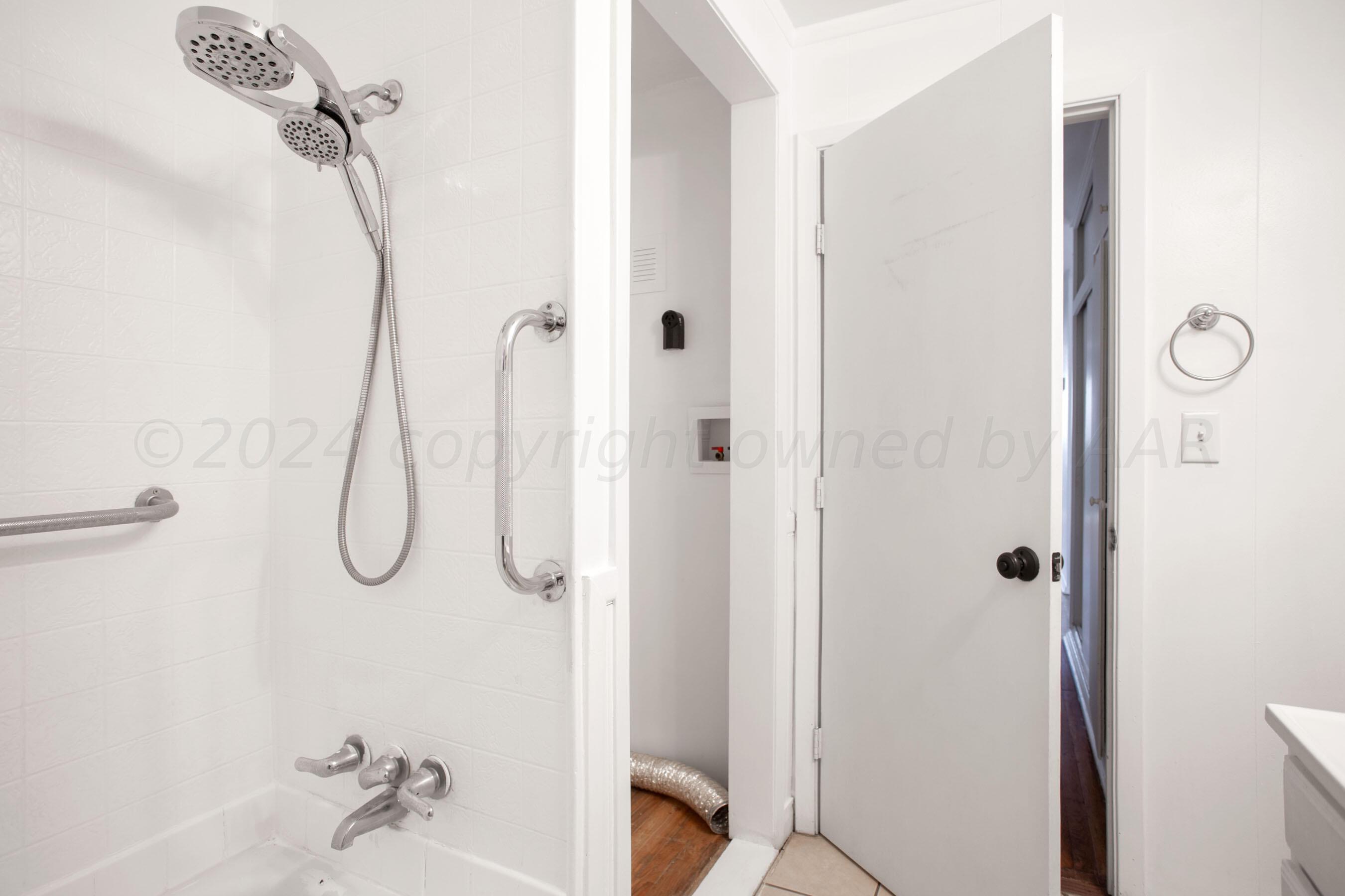 5318 Albert Avenue Amarillo, TX 79106 - Photo 21 of 24 a bathroom with a glass shower door