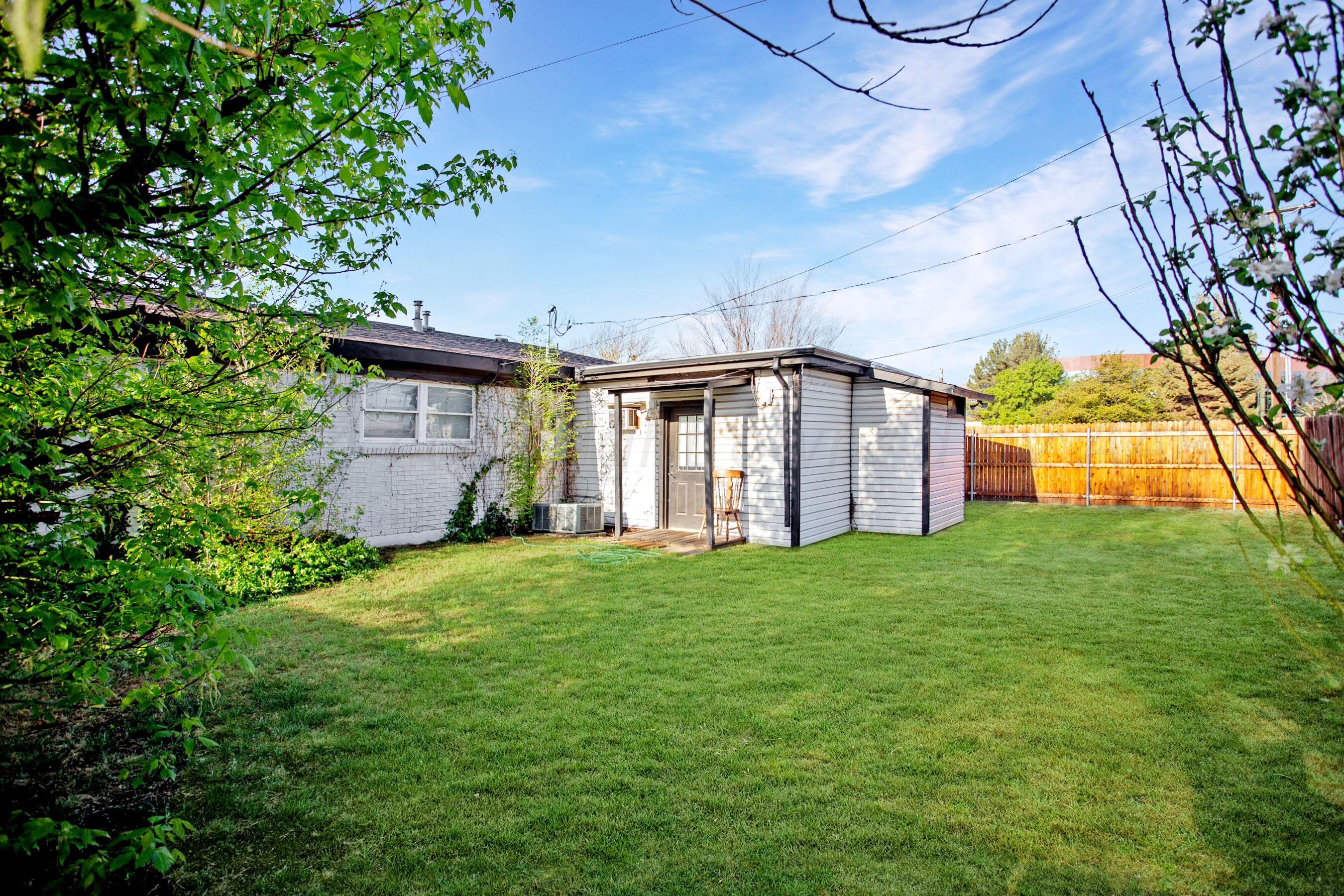 5318 Albert Avenue Amarillo, TX 79106 - Photo 23 of 24 a view of a backyard with potted plants and large trees