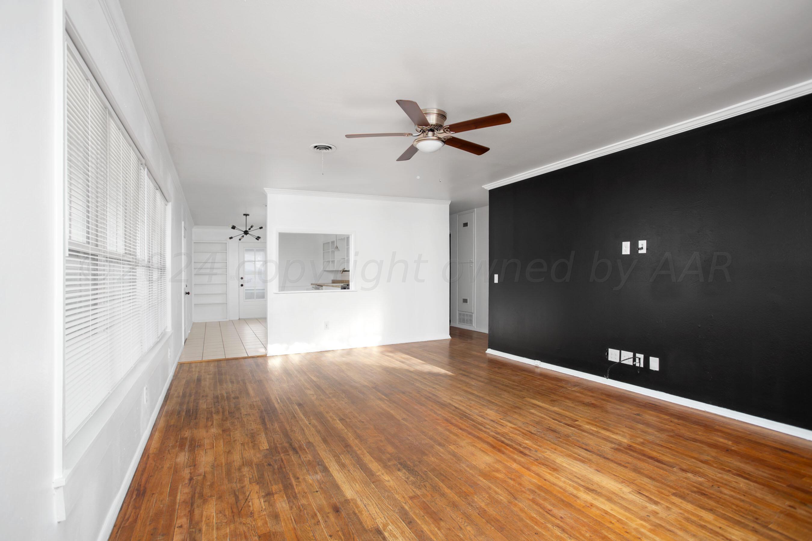 5318 Albert Avenue Amarillo, TX 79106 - Photo 3 of 24 a view of empty room with wooden floor and fan