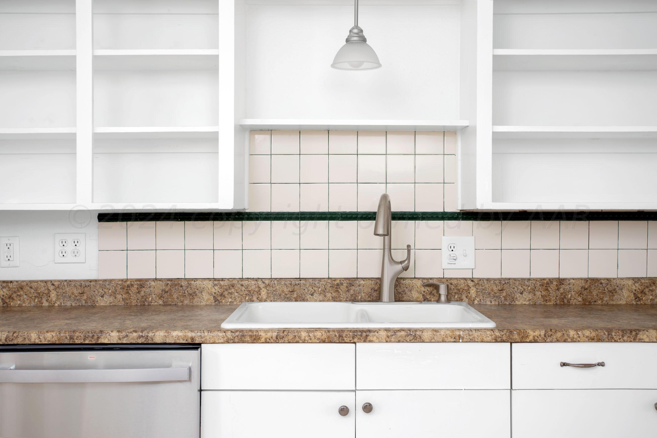 5318 Albert Avenue Amarillo, TX 79106 - Photo 8 of 24 a kitchen with granite countertop a coffee maker on top and cabinets