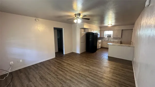 a view of a kitchen with a sink and refrigerator
