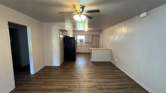 a view of a kitchen with a sink and a refrigerator