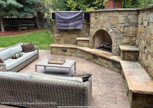 a view of an outdoor sitting area with a fire pit and outdoor seating
