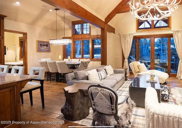 a living room with furniture fireplace and large window