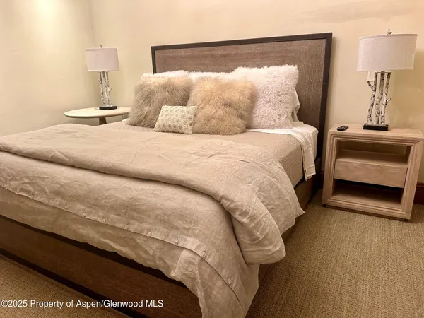 a bed sitting in a bedroom and lamp