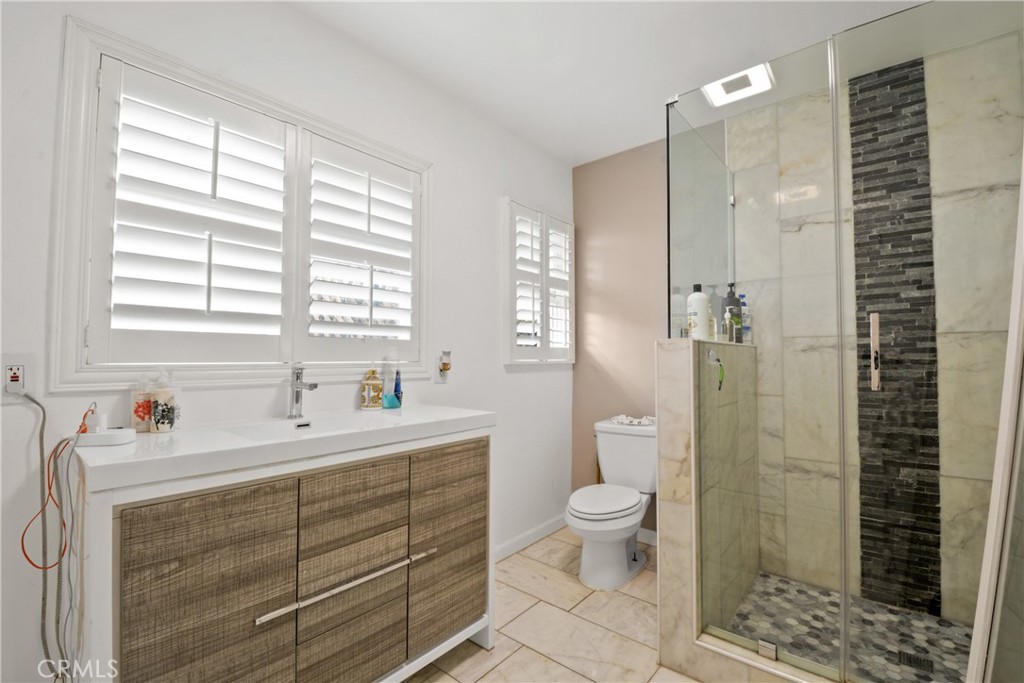 627 West Front Street Covina, CA 91722 - Photo 12 of 16 a bathroom with a sink a toilet and shower