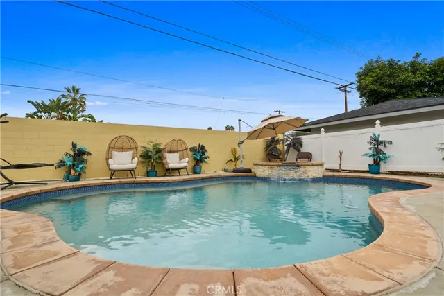 a view of a swimming pool with outdoor seating